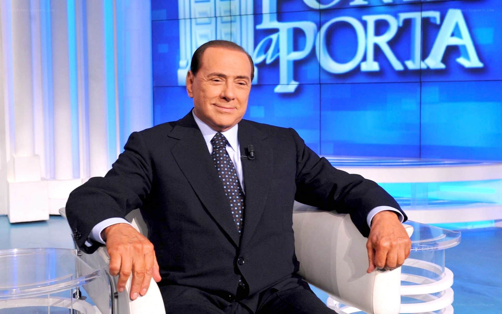 Man in suit on talk show set