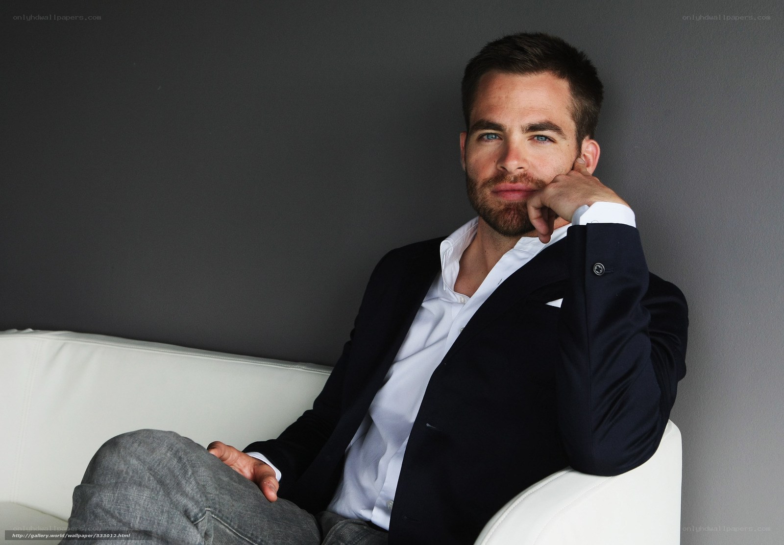 man in suit on white couch