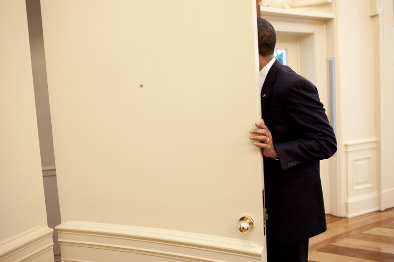 Man in Suit Opening Door