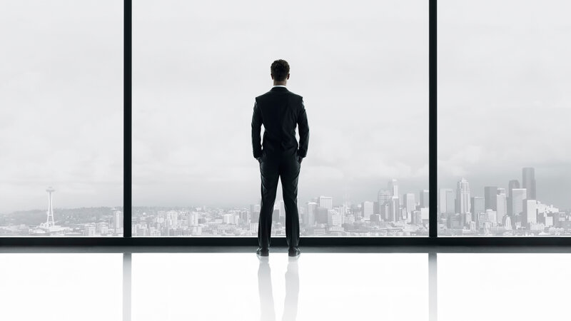 Man in suit overlooking city
