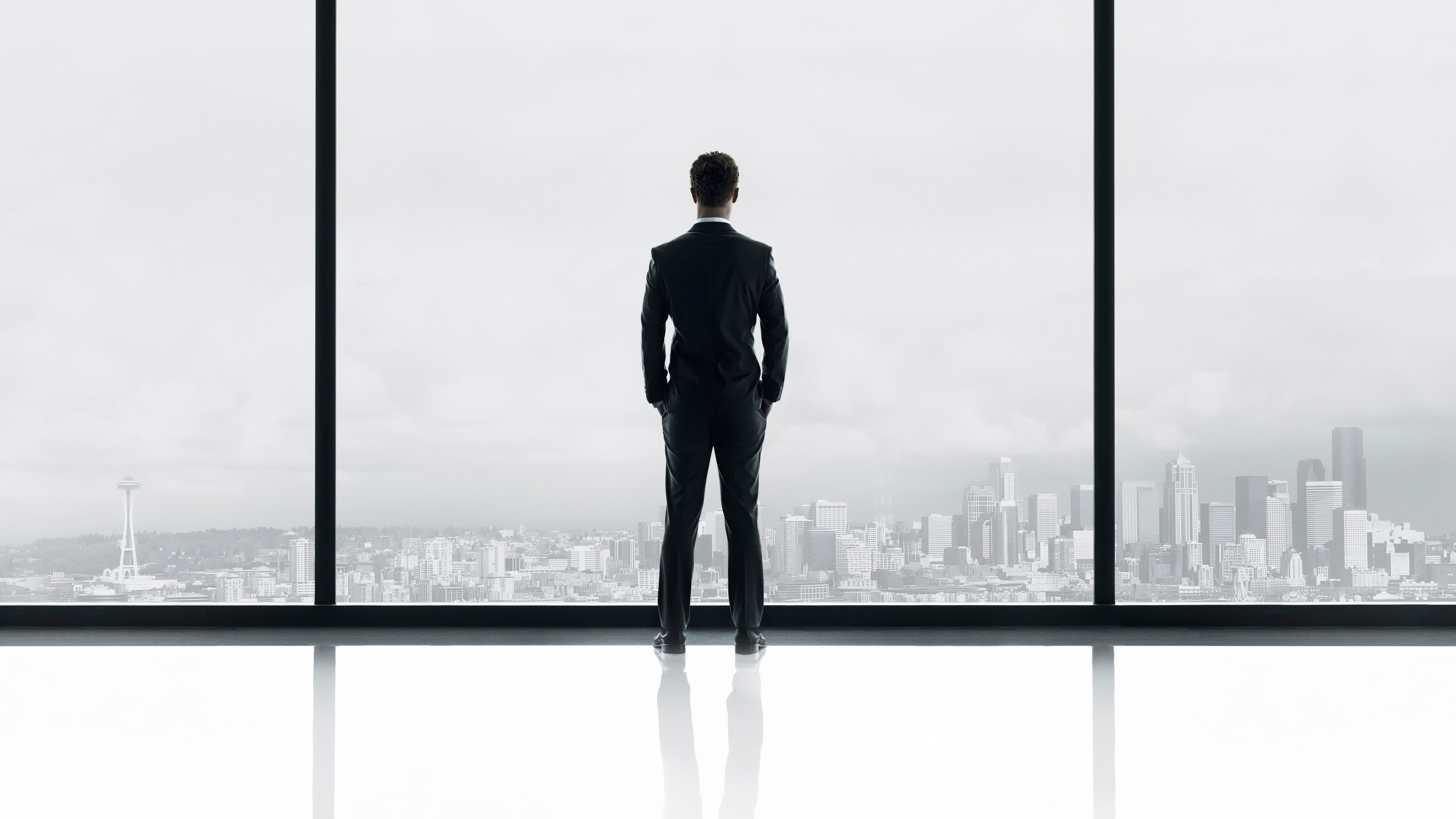 Man in suit overlooking city
