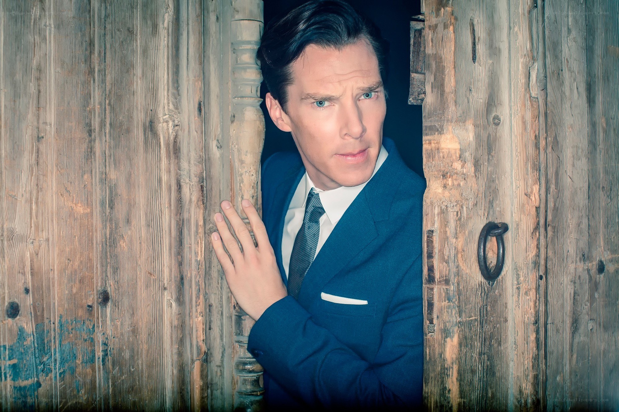 man in suit peeking through door