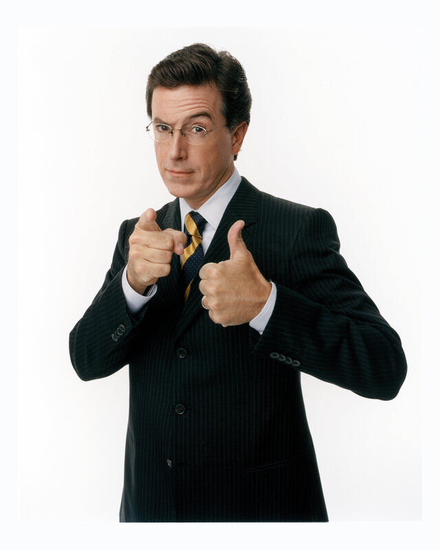 Man in suit pointing and giving thumbs up