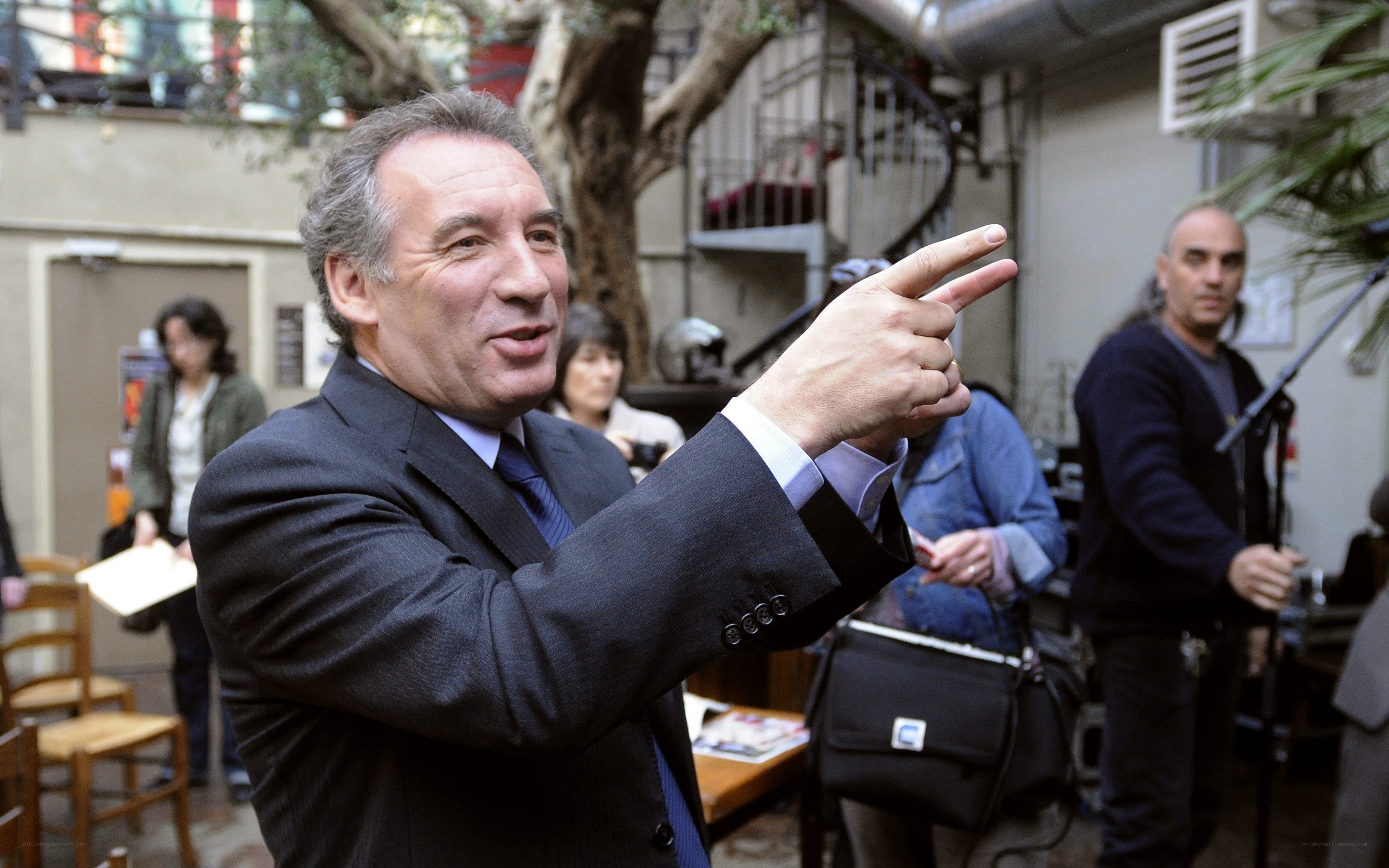 Man in suit pointing at something