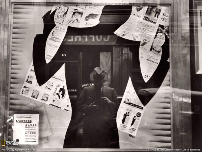 Man in suit reflected in window
