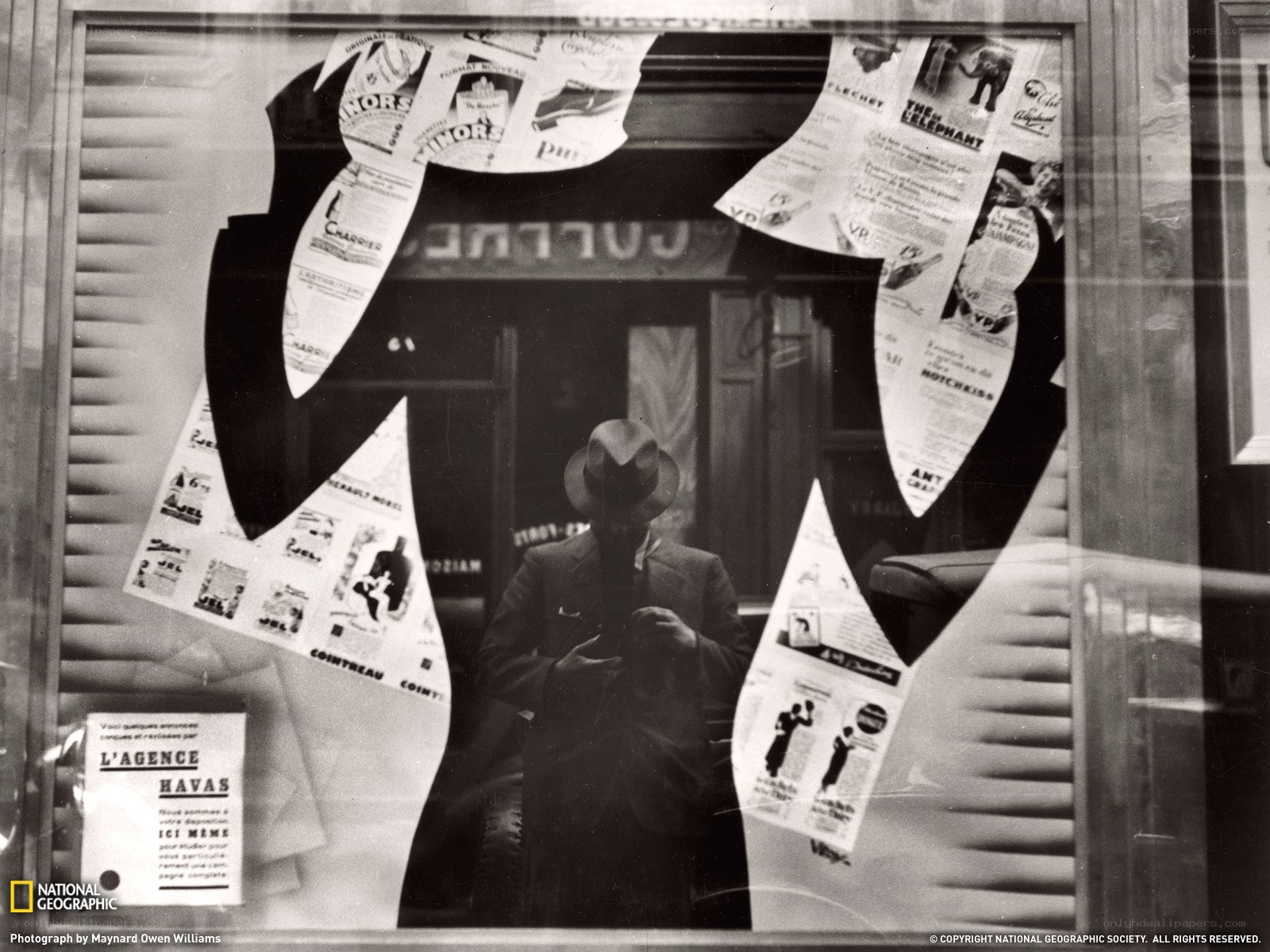 Man in suit reflected in window