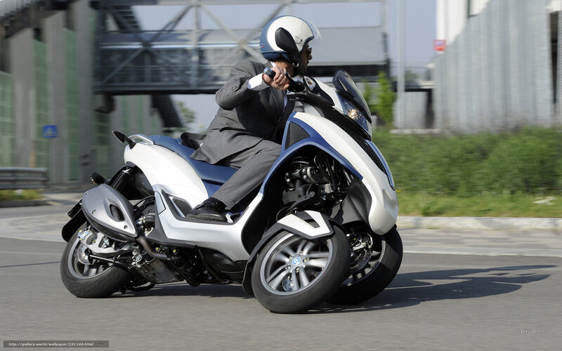 Man in suit riding scooter