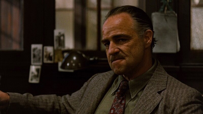 man in suit sitting at desk