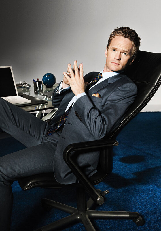 man in suit sitting at desk
