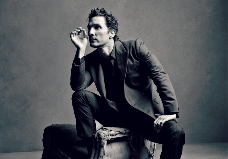 Man in Suit Sitting — Black, Dramatic, Photograph