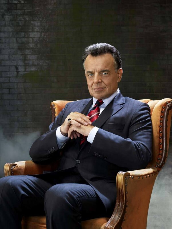 man in suit sitting in chair