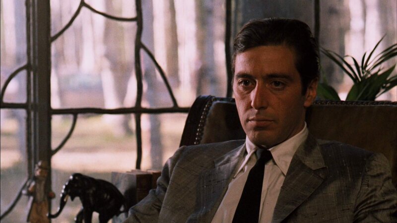 man in suit sitting in chair
