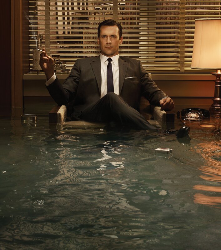 man in suit sitting in flooded room