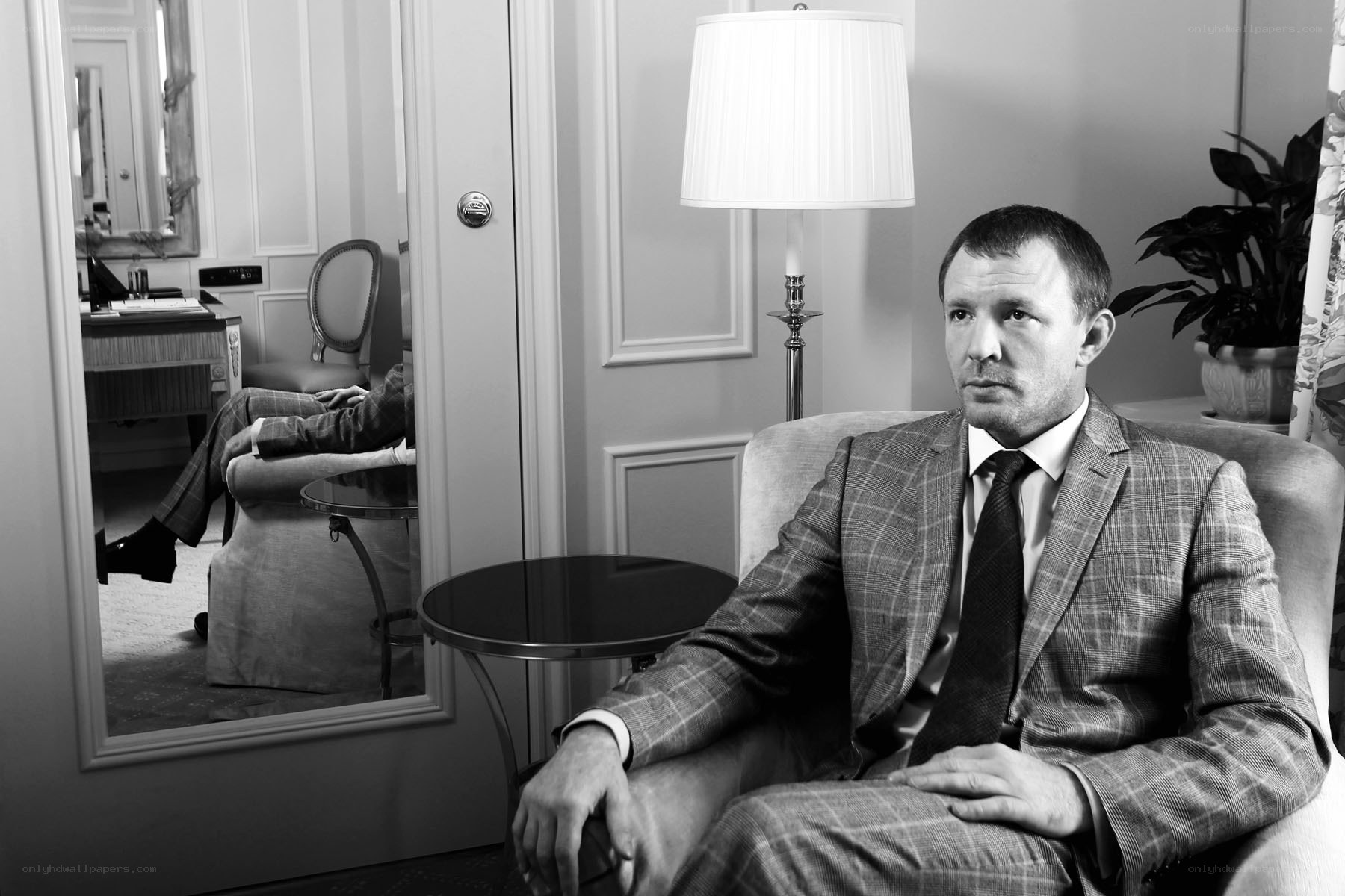 Man in suit sitting in room