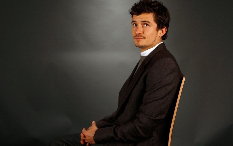 man in suit sitting on chair