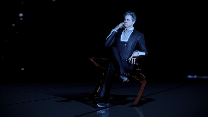man in suit sitting on chair