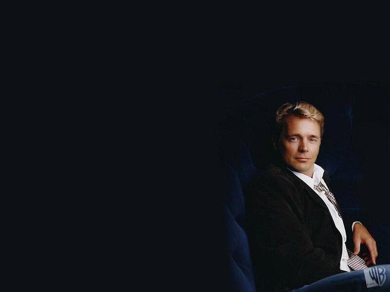 man in suit sitting on chair