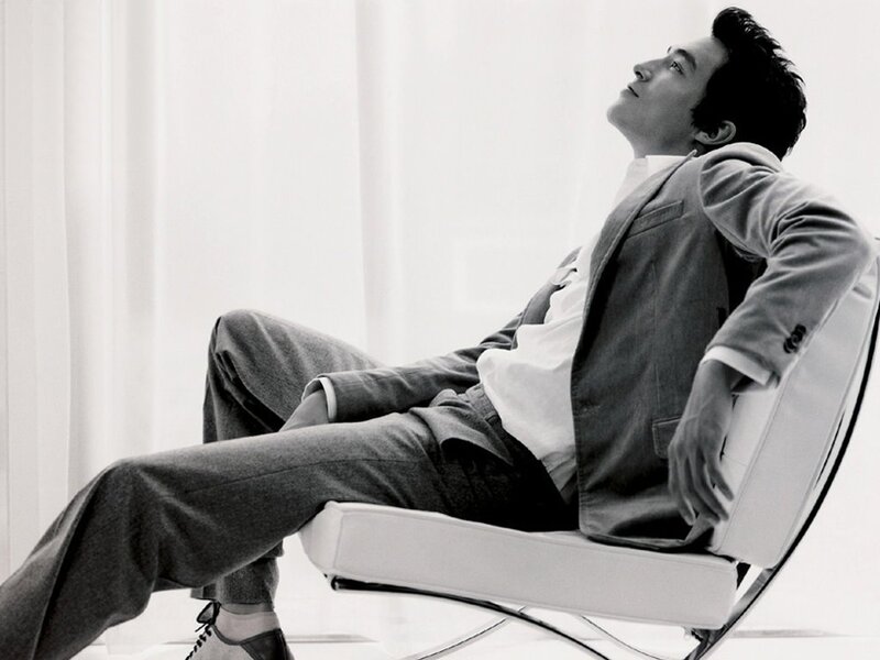 man in suit sitting on chair