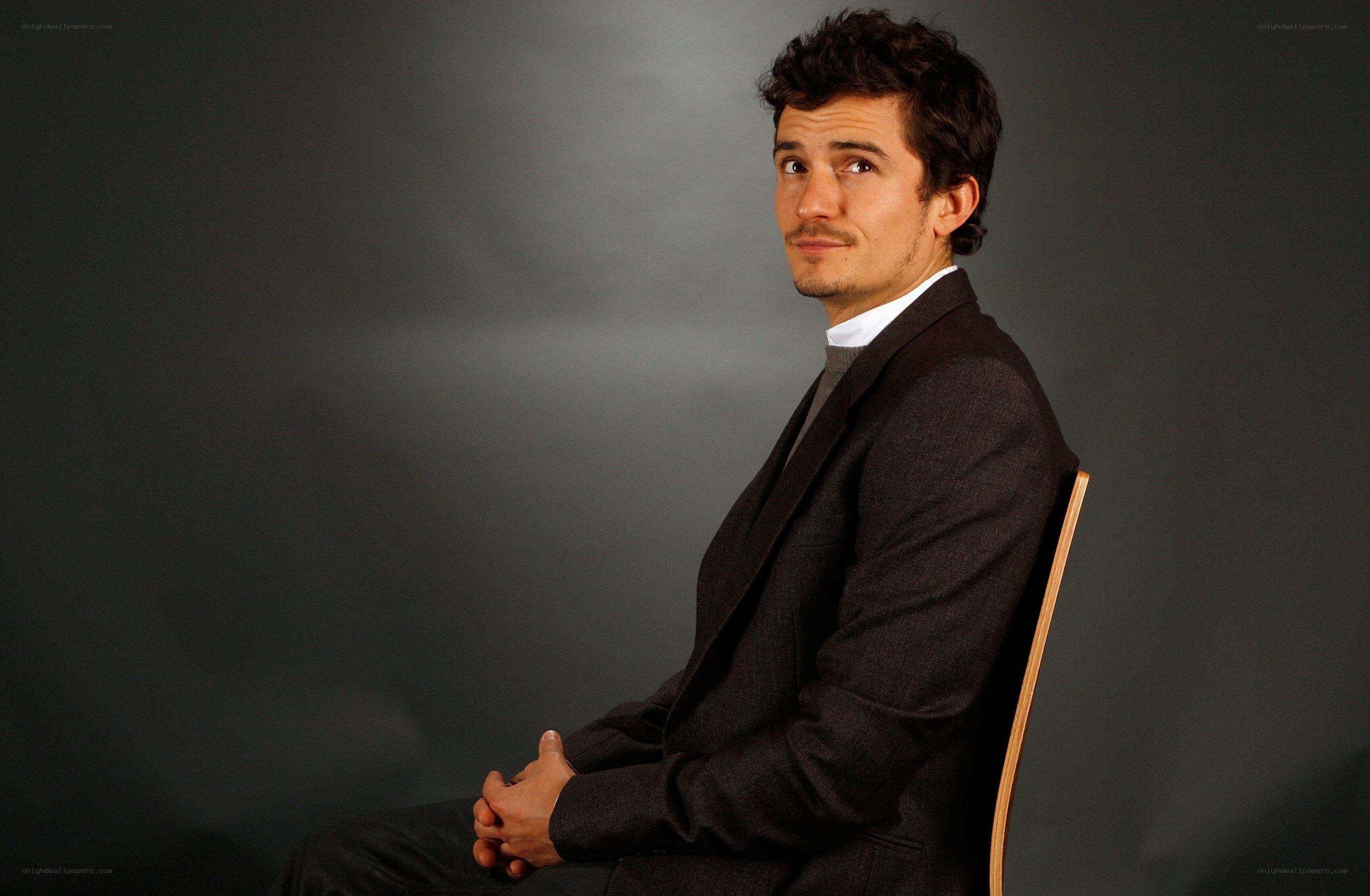 man in suit sitting on chair