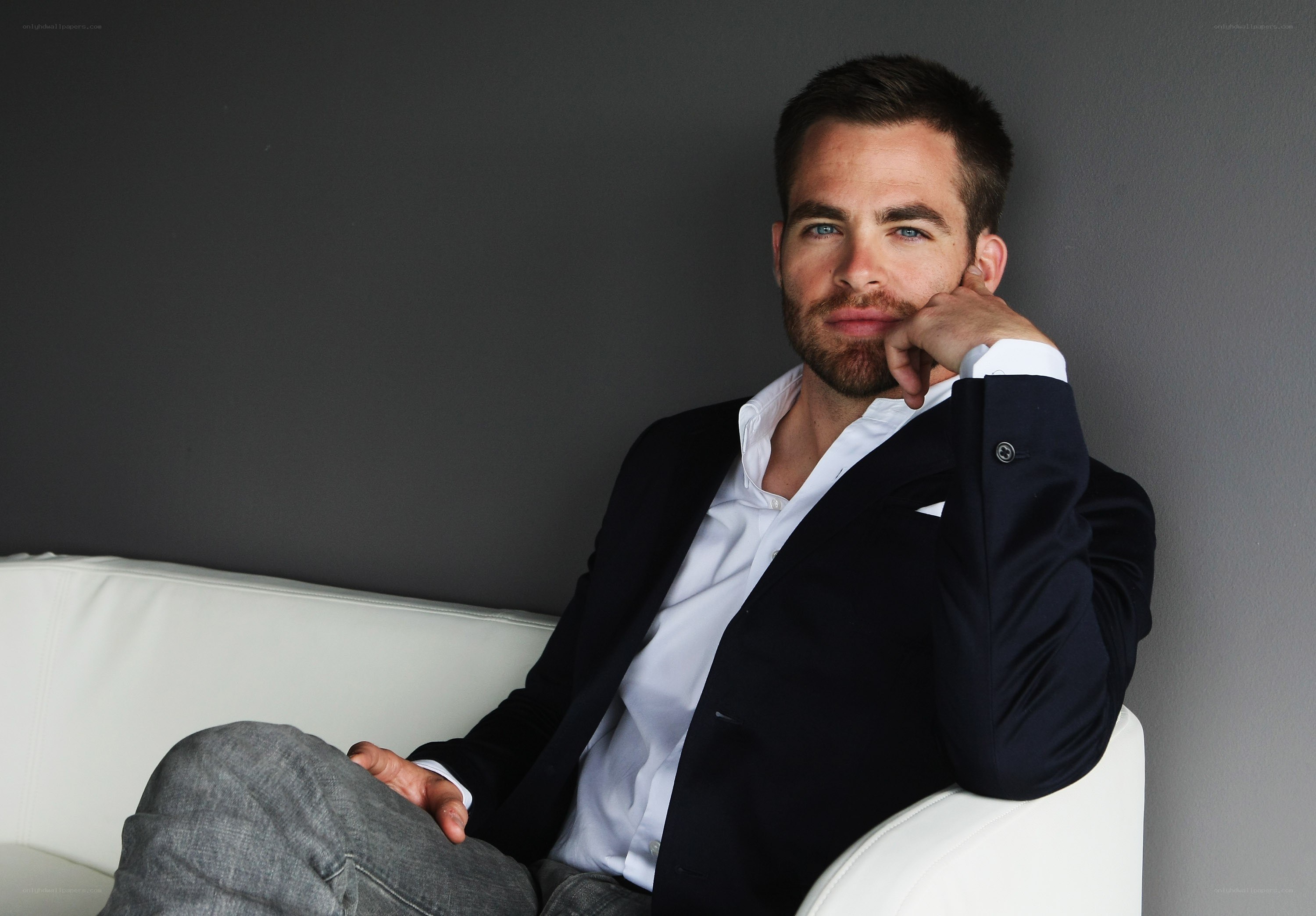 man in suit sitting on couch