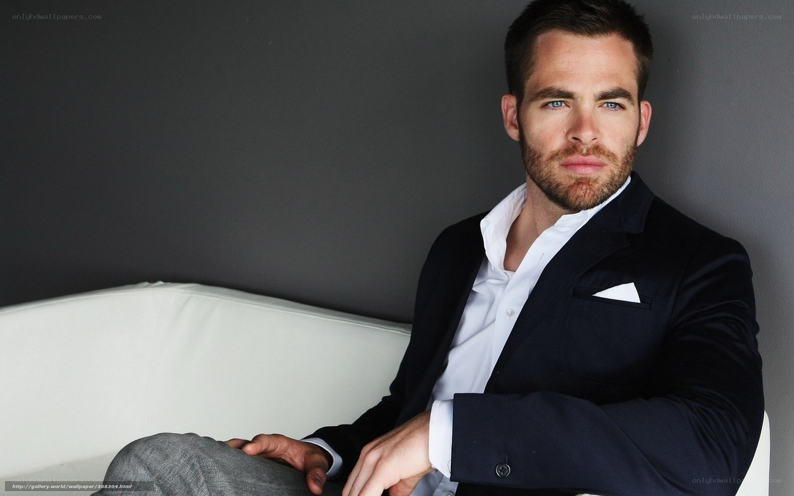 man in suit sitting on couch
