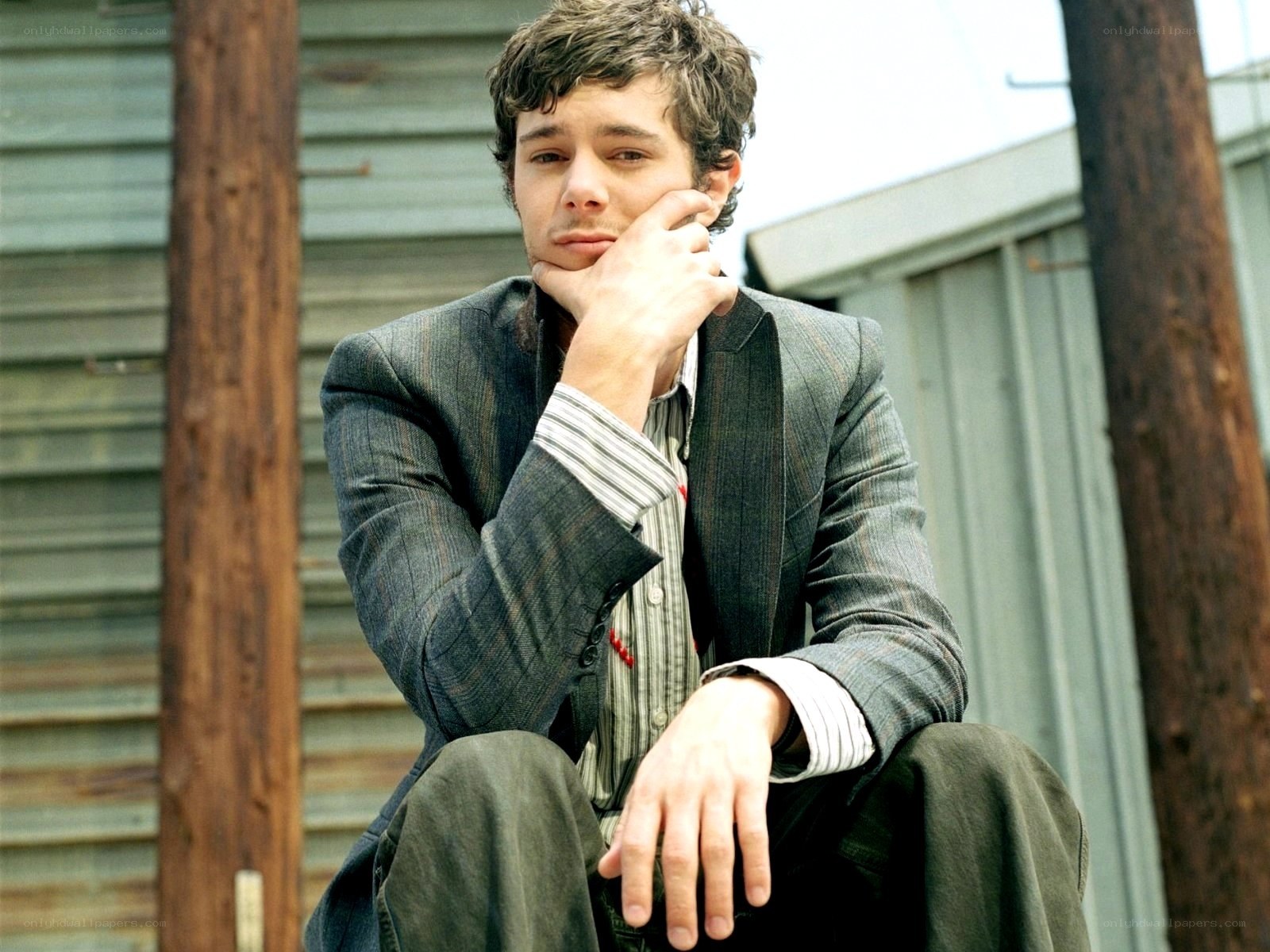 man in suit sitting thoughtfully