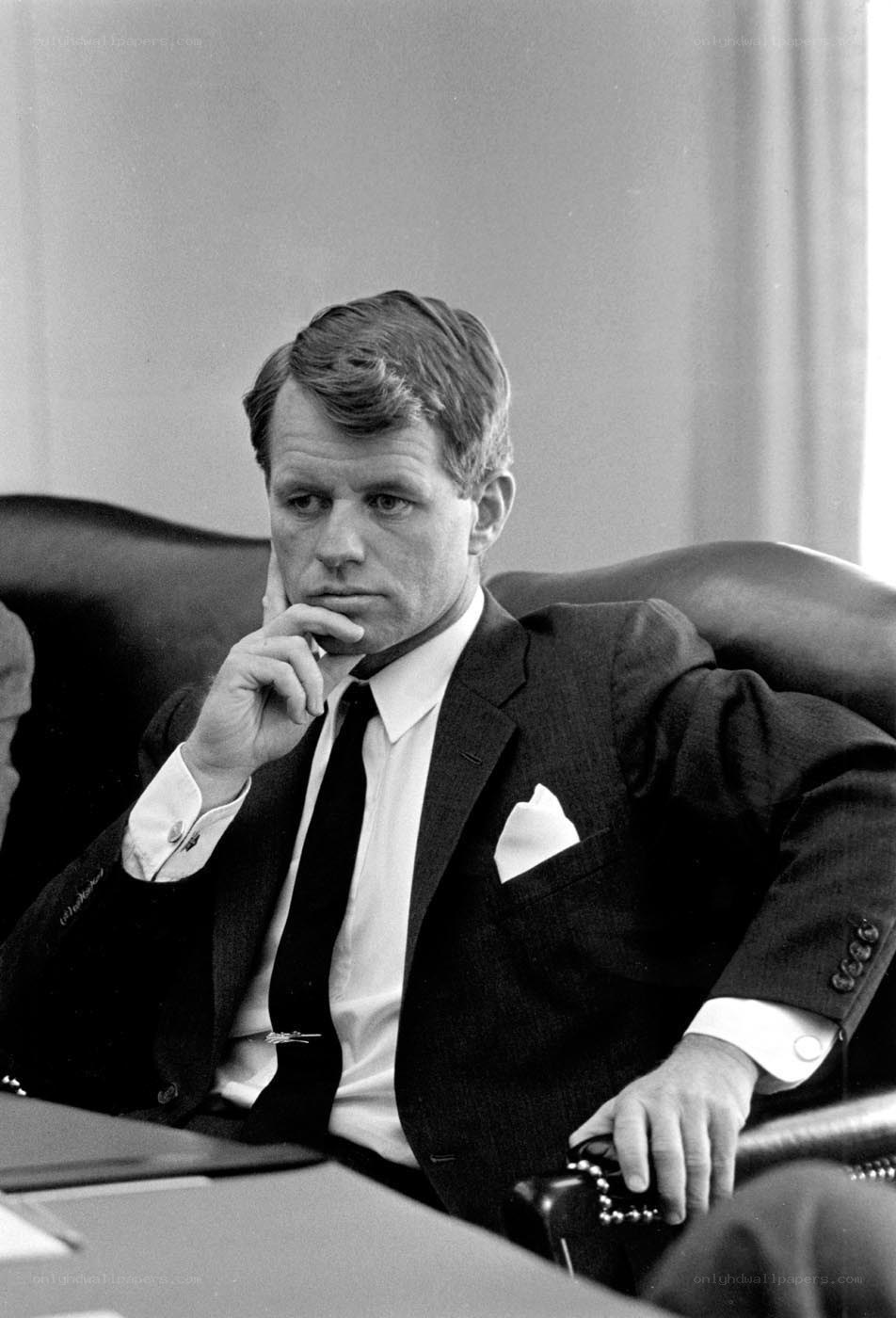 Man in suit sitting thoughtfully