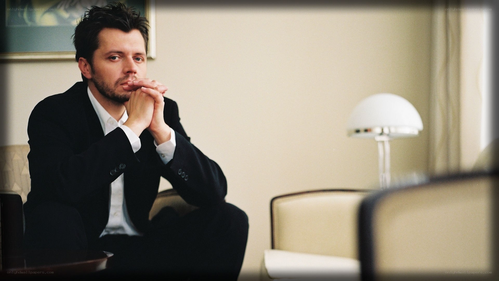 man in suit sitting thoughtfully