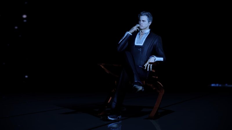 man in suit sitting with cigarette