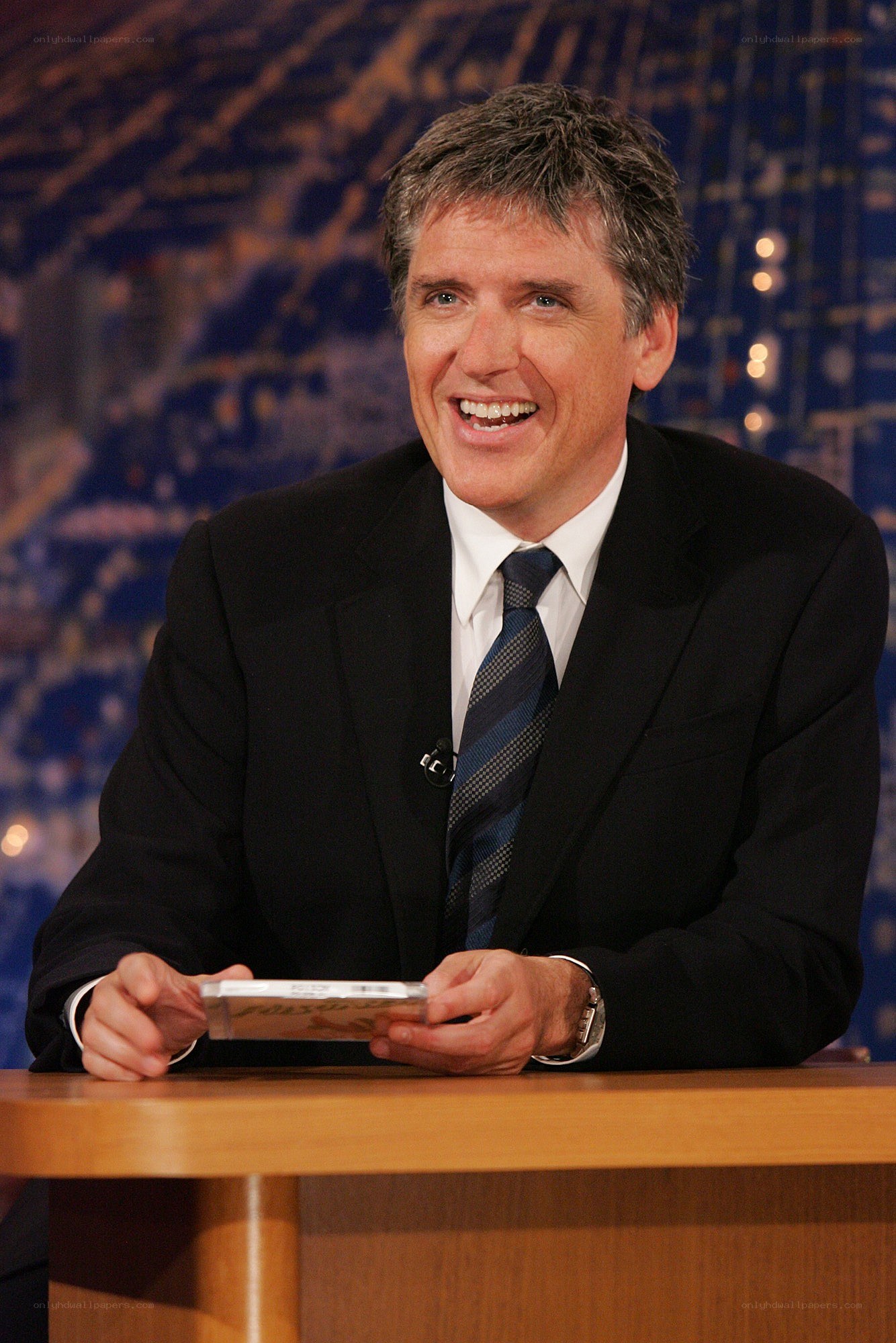 man in suit smiling at desk