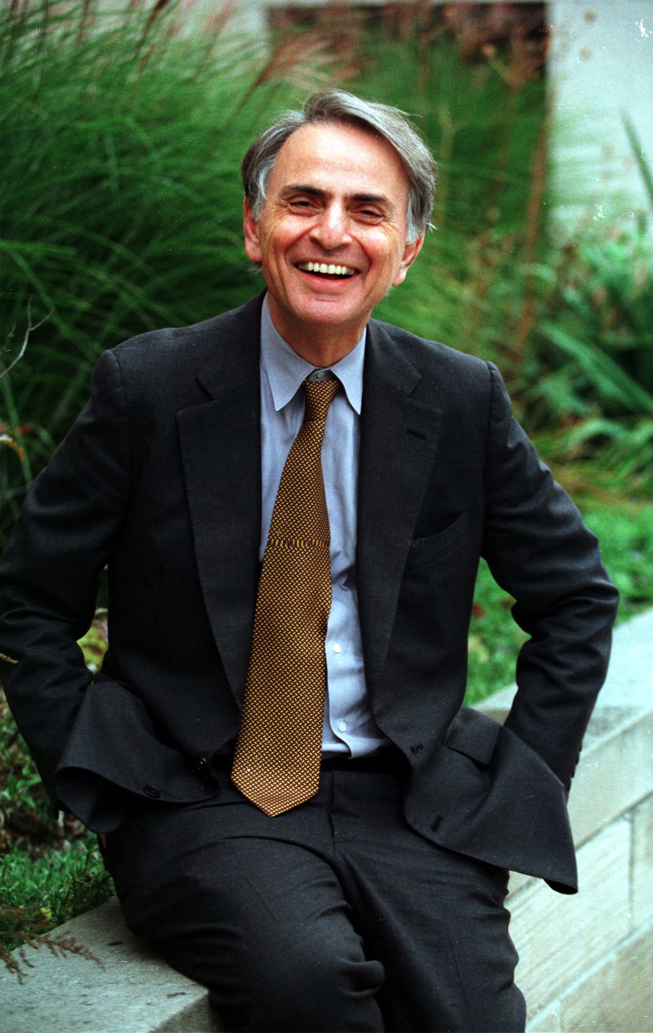 Man in suit smiling outdoors