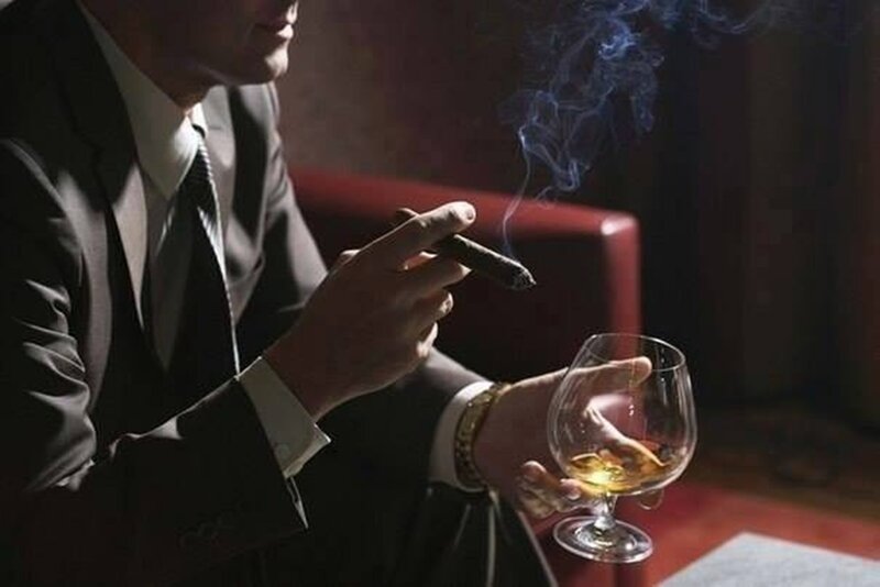 Man in Suit Smoking Cigar — Black, Dramatic