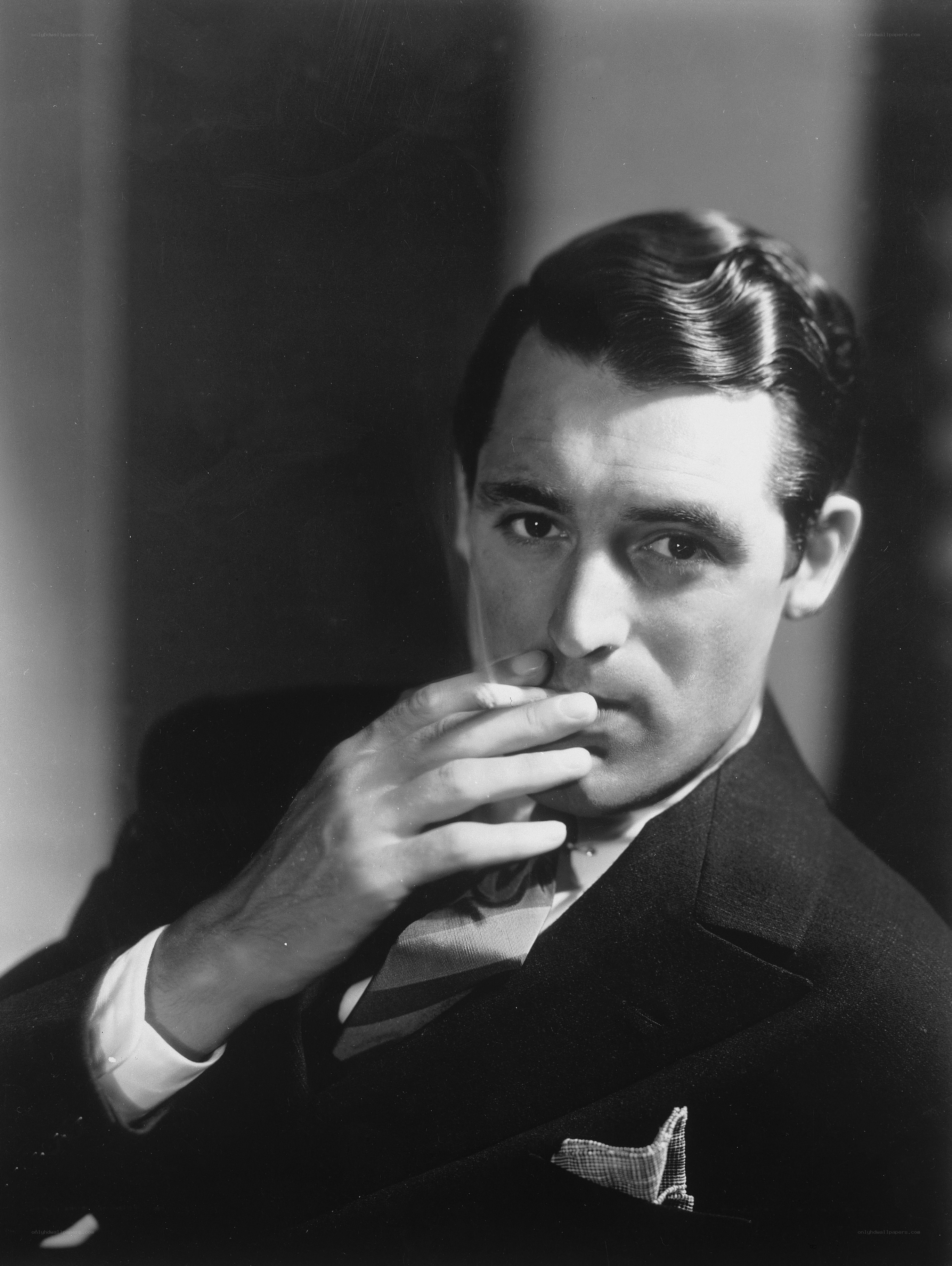 man in suit smoking cigarette