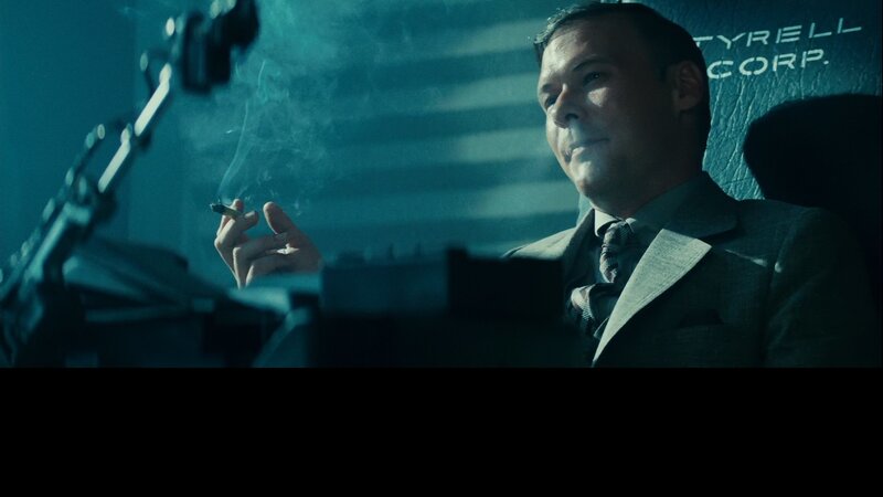 man in suit smoking cigarette