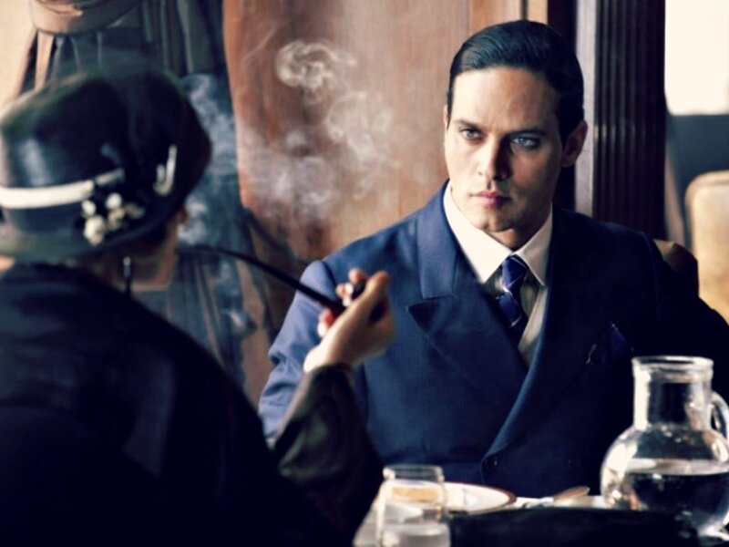 Man in Suit Smoking Pipe