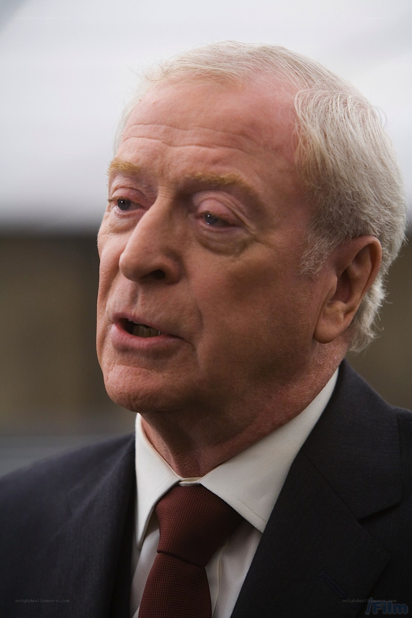 man in suit speaking