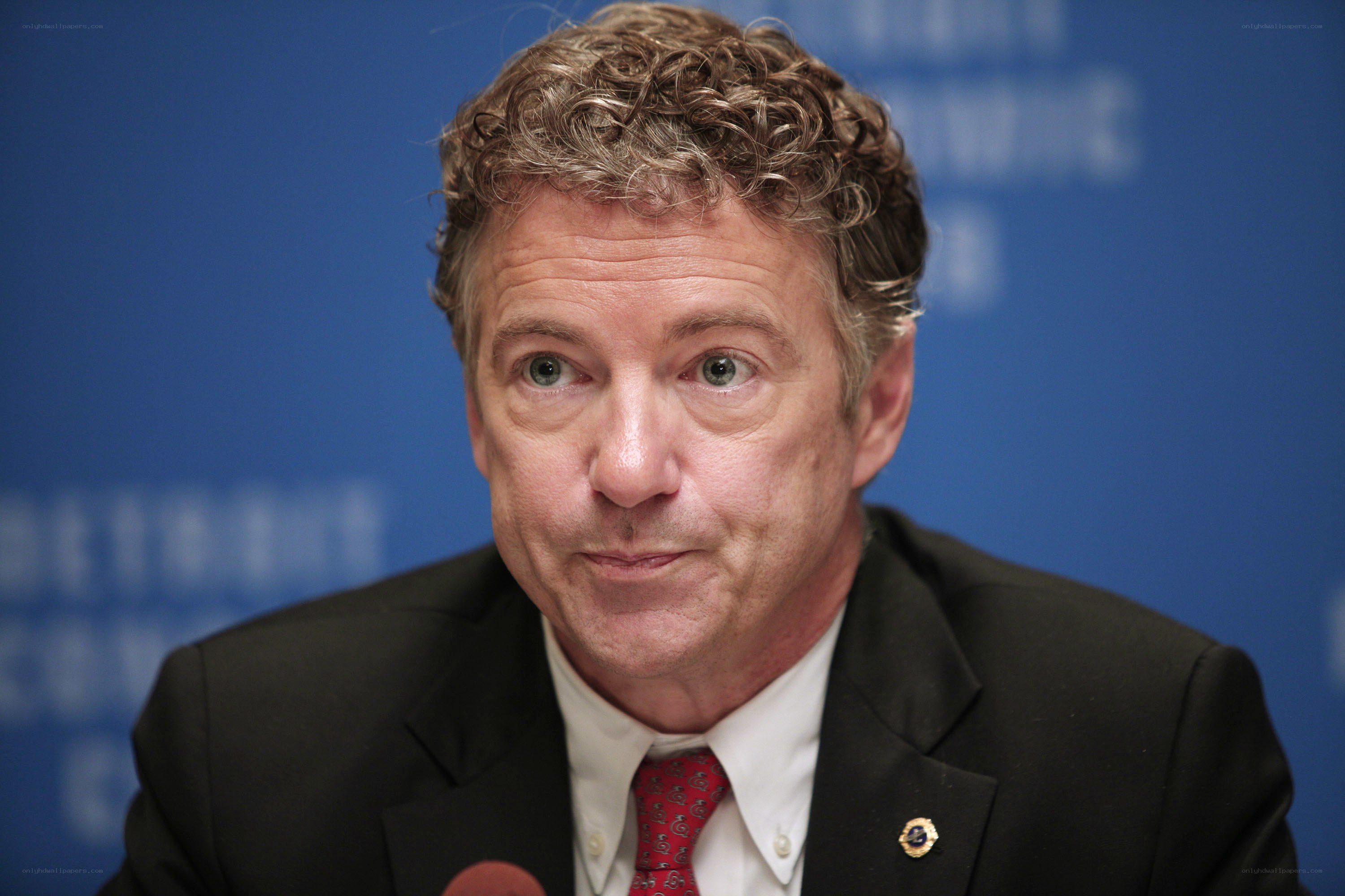 man in suit speaking at podium