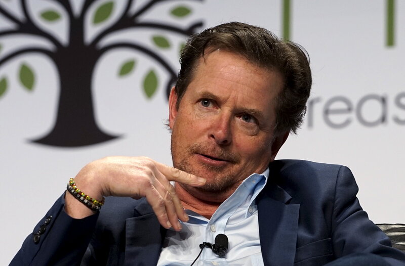 Man in Suit Speaking — Blue, Serious, Photograph, Tree Logo
