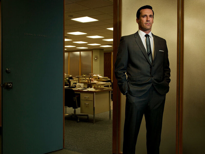 Man in suit standing by office door