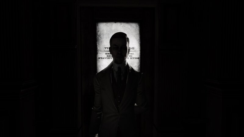 man in suit standing in doorway