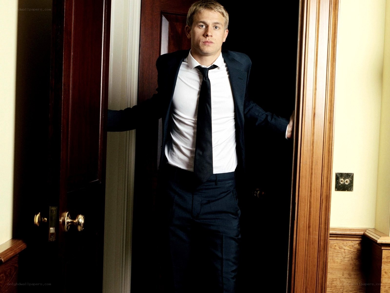 man in suit standing in doorway