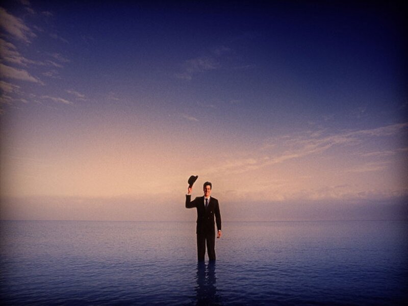 man in suit standing in water