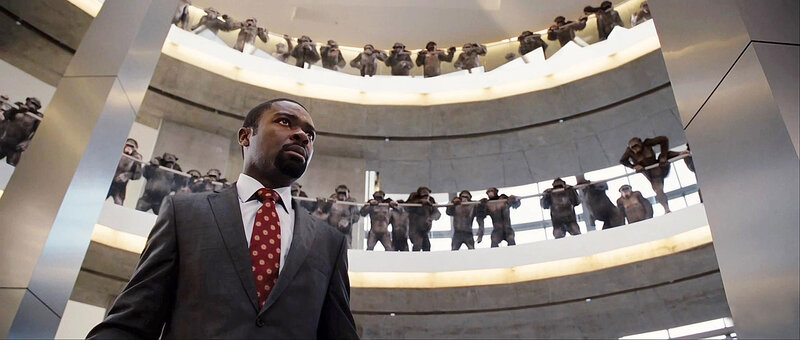 Man in Suit Surrounded by Apes