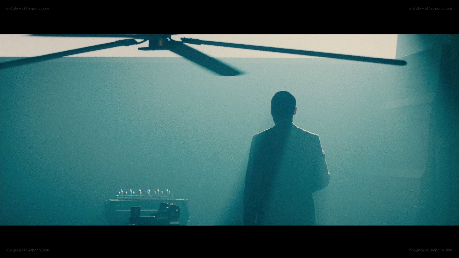man in suit under ceiling fan