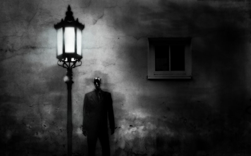 man in suit under street lamp