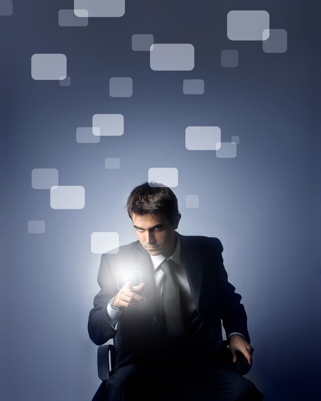 Man in Suit Using Tablet