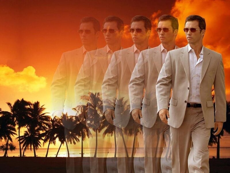 man in suit walking on beach