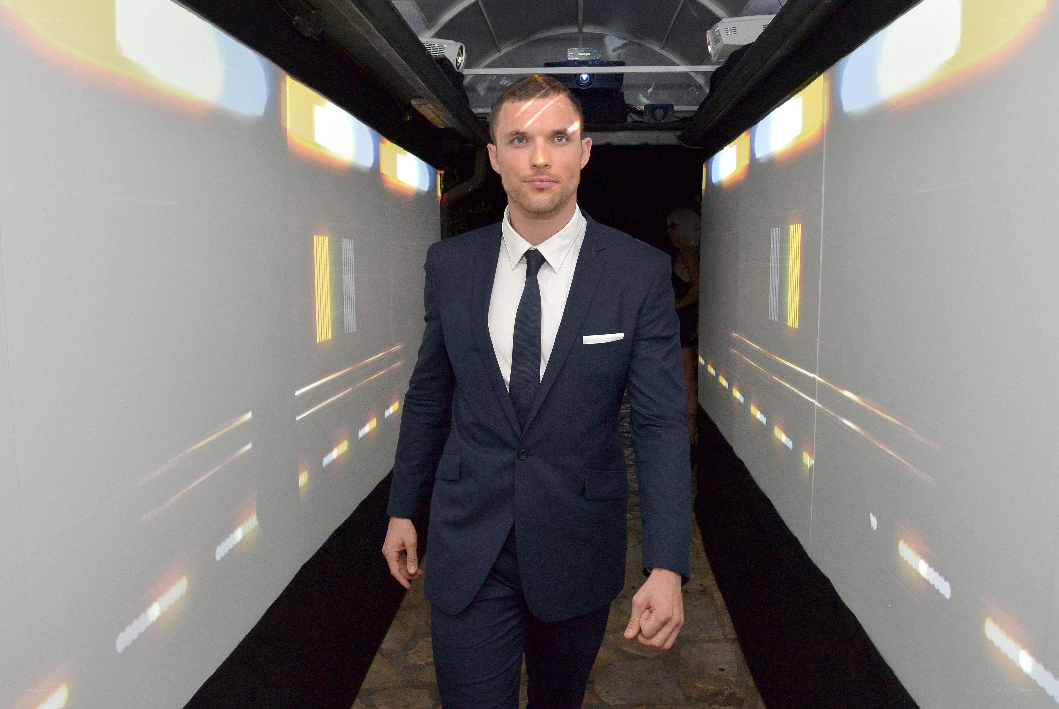 man in suit walking through tunnel