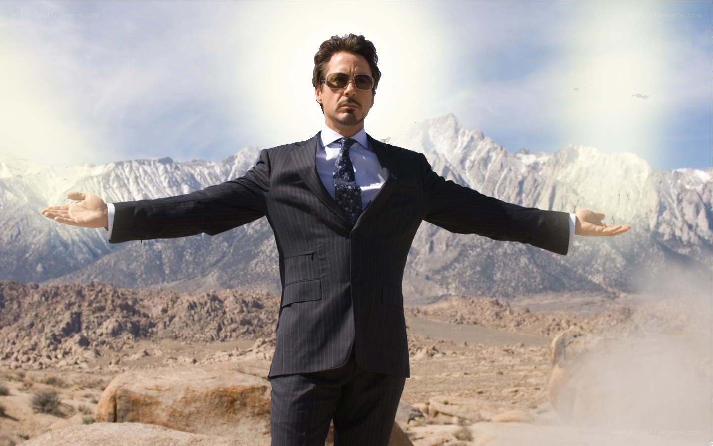 man in suit with arms outstretched