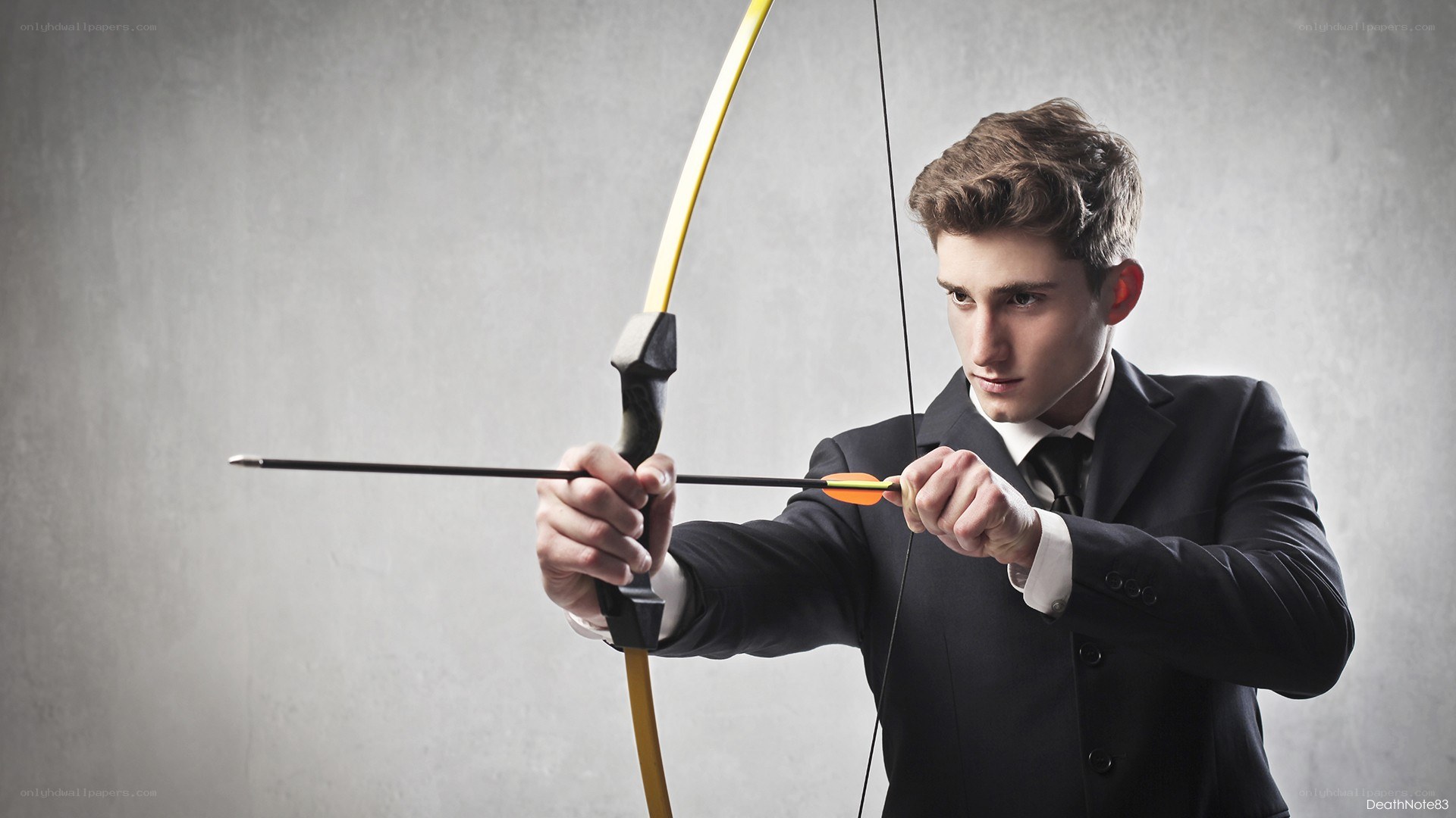 man in suit with bow and arrow